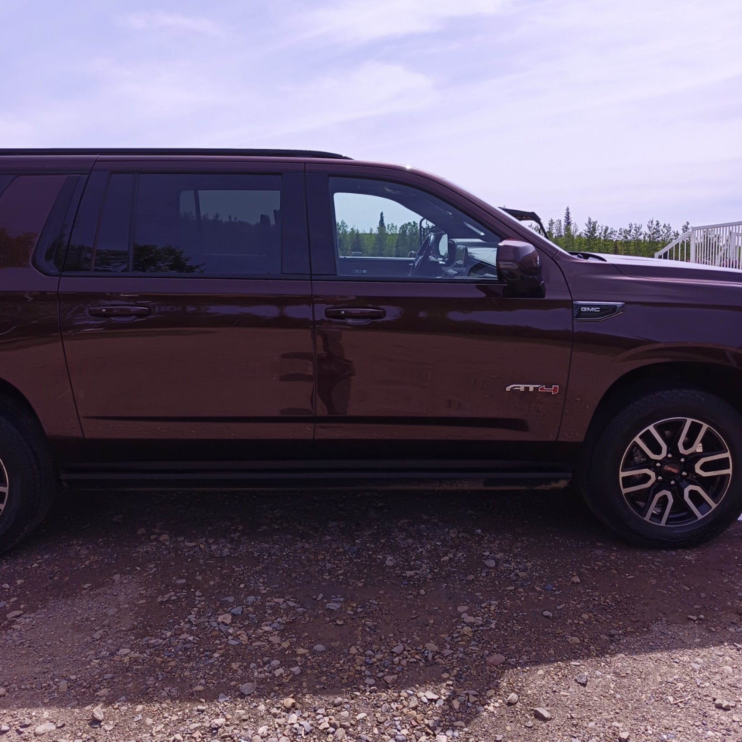 Side profile of a GMC Yukon AT4 SUV before professional detailing service in Dawson Creek BC.